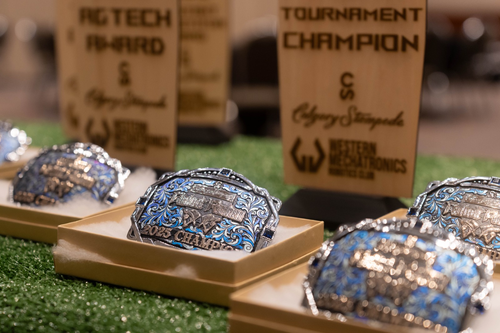 Calgary Stampede Robot Rodeo tournament champion belt buckles engraved with the Western Mechatronics logo
